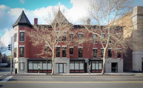 Nearing completion in this photo, the renovation's elegant new storefront bays can be seen along the U Street sidewalk, as well as the new masonry base for the central bay. Main facade after renovation