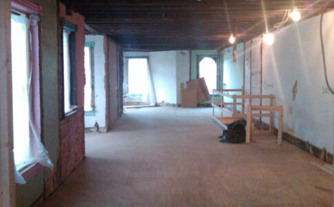 On the interior, a new slab was poured, both upper floors were reframed, and the roof structure was reinforced. New steel columns and beams replaced an internal masonry wall in order to create a single unimpeded open space on each level. All plumbing and electrical systems were replaced in entirety. Historic building with new open flloor plan