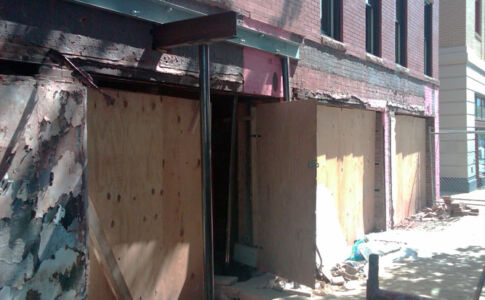 Significant structural intervention was required: extensive foundation underpinning, steel bracing to shore up masonry walls and openings, new floor framing. Historic building structural damage, repairs