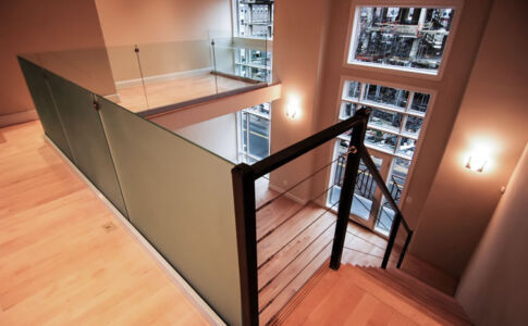 Loft space in the penthouse units provides guest accommodations or a sleek home office Modernist cable railing architectural detail