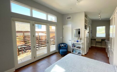 A compact, efficient layout with vaulted ceiling and plenty of daylight helps this small ADU feel more spacious. Photo of ADU interior