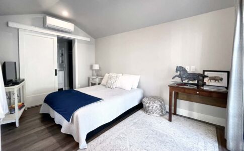 The all-electric studio ADU features a living/sleeping area, full bath, and full (mini) kitchen, all within 235 square feet. Photo of garage conversion studio ADU