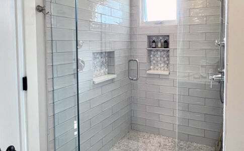 Like the remodeled guest bath, the new master bath features a generous custom shower. Photo of new master bath shower with custom tile