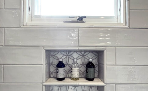 Tiled niche beneath a frosted glass privacy window. Photo of new master bath shower niche