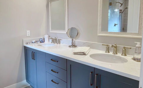 Making use of space that had formerly been the laundry room, a spacious new master bath was added -- increasing the number of bathrooms in the house to two. Photo of new master bath vanity cabinets