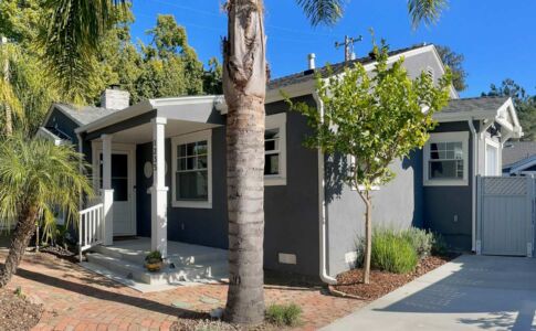 The exterior of the house was updated with new detailing, a side entry vestibule, and a welcoming new front porch. Photo of remodeled house in SLO