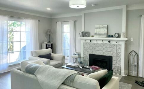 The living room fireplace got a makeover, as did the lighting in the room. Interior design credits to Tana Mattson of Altstadt Interiors, altstadtinteriors.com. Photo of renovated living room