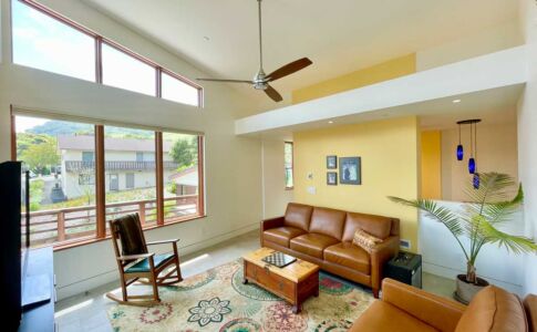 Looking back towards the rest of the house, the family room offers a peek into the stair hall beyond. Photo of light-filled family room