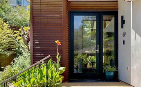 Exterior materials were chosen not simply for their beauty. Smooth stucco, corrugated and flat panel steel, slate, and stained concrete require practically no maintenance and are wildfire resistant as well. Photo of home with modern detailing