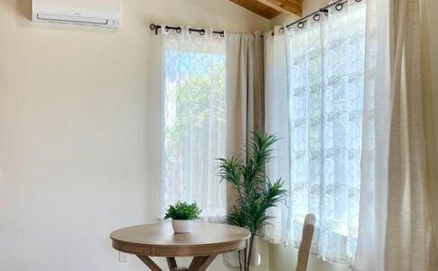 The interior of the ADU features exposed concrete floors and eye-catching stained wood ceilings. On winter days, the concrete floor absorbs the sun's energy, slowly radiating that energy in the evening to help warm the space; the high summer sun is blocked out by carefully-sized overhangs, helping to keep the space cooler during those months. Dining area of new construction ADU