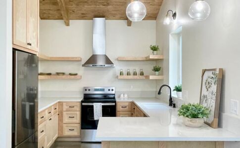 Cathedral ceilings and generously-sized windows allow gentle natural light to flood the living spaces. Thanks to the volume and open layout, the ADU feels much larger than its actual square footage. Kitchen with wood ceiling